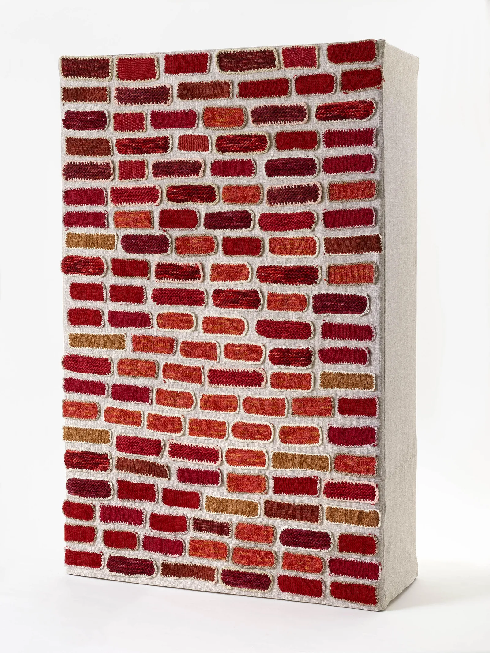 "Brick By Brick" 2018. Aims to challenge the boundaries imposed between fellow humans. It invites us to open dialogue. Materials: hand-dyed wool on repurposed wooden spools.