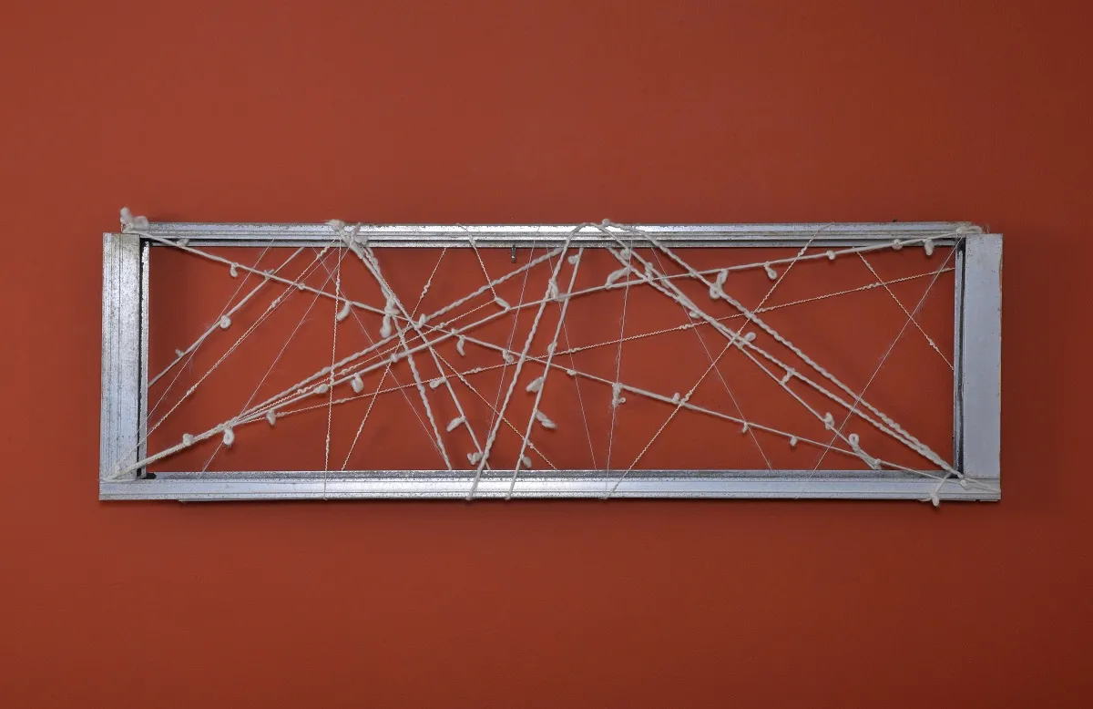 "Hugging You" 2015. 36" x 11" x 1". Natural wool on reclaimed window frame.