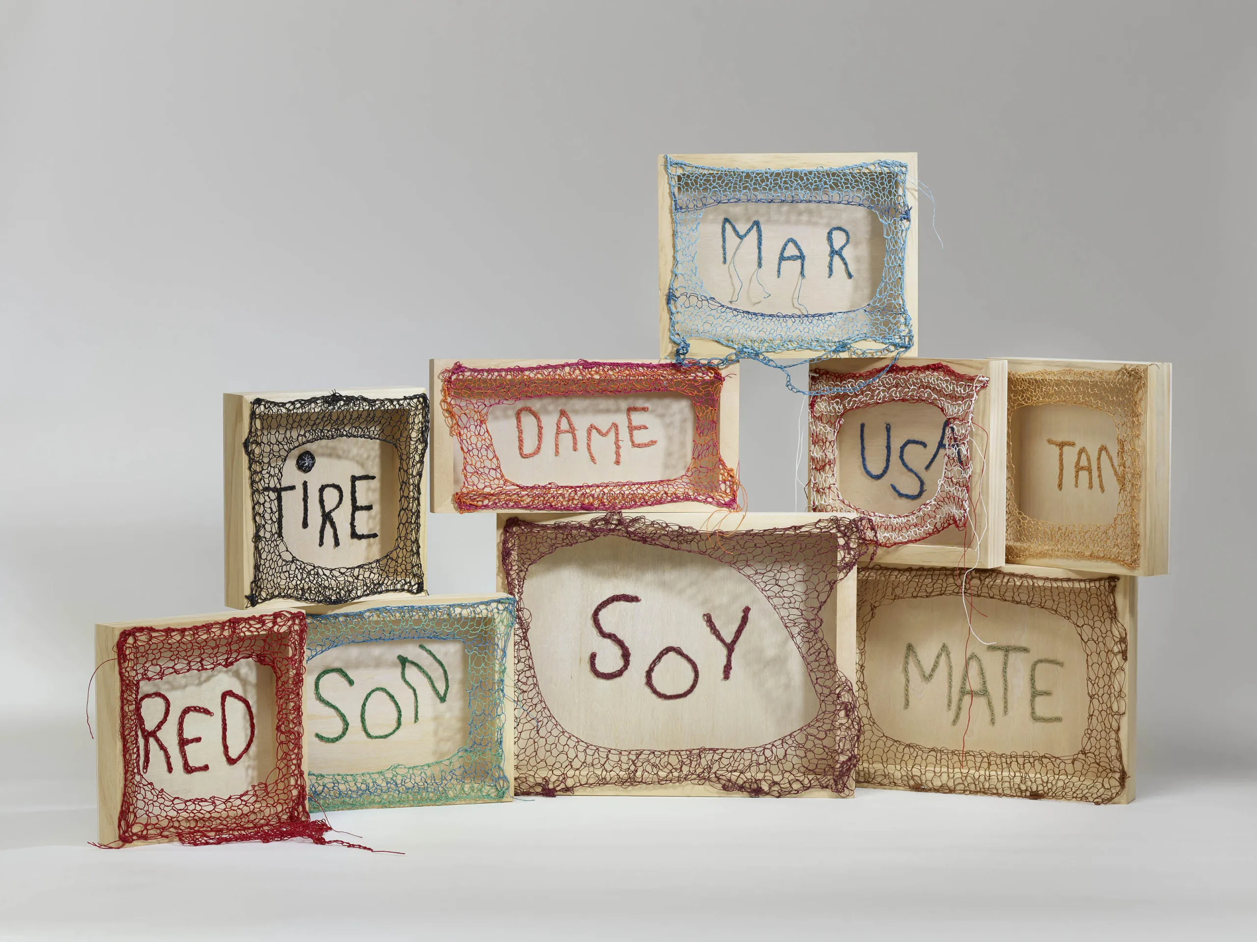 "Lost and found in translation" 2020. Crocheted and knit notes with waxed linen and cotton yarns on wire grid. Metal frames. 4 panels, 20" x 20" each.
