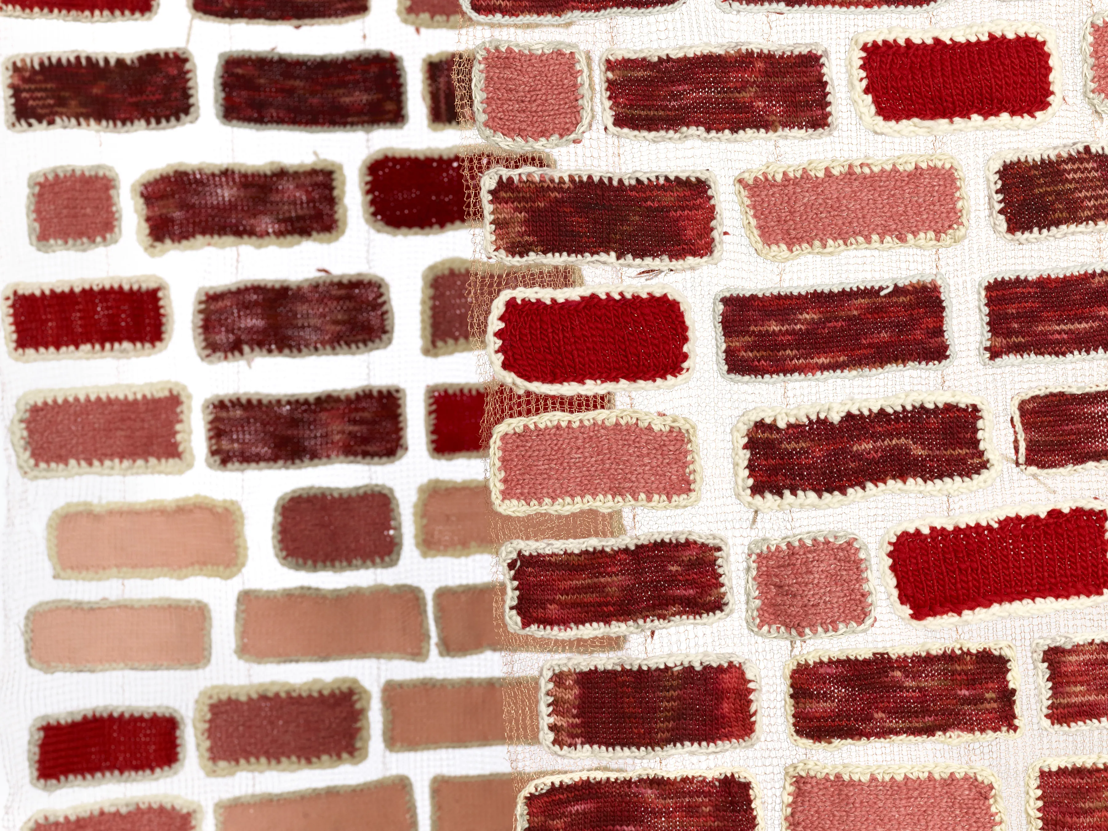 “Walking through brick walls.” 2019. 3 panels, 7’ x 30” each. Yarn bricks sewn onto copper wire knit mesh.
